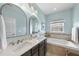 This bathroom boasts double sinks, a soaking tub, and a soothing color palette at 309 Old Mill Village Dr, Apex, NC 27502
