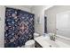This bathroom features a floral curtain, an oversized mirror, and natural light at 309 Old Mill Village Dr, Apex, NC 27502