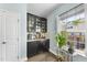 Cozy butler's pantry features dark cabinets, granite counters, and decor at 309 Old Mill Village Dr, Apex, NC 27502