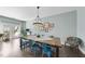 Stylish dining area featuring a rustic wood table, designer lighting, and an outdoor view at 309 Old Mill Village Dr, Apex, NC 27502