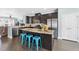 Modern kitchen with stainless steel appliances, granite countertops, and a breakfast bar at 309 Old Mill Village Dr, Apex, NC 27502