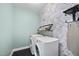 The laundry room boasts modern appliances, stylish wallpaper, and tile floors at 309 Old Mill Village Dr, Apex, NC 27502