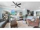 Inviting living room with fireplace, ceiling fan, and open view to modern kitchen at 309 Old Mill Village Dr, Apex, NC 27502