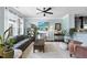 Bright living room featuring a fireplace, ceiling fan, and a comfortable seating area at 309 Old Mill Village Dr, Apex, NC 27502