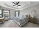 This bedroom offers a tray ceiling, windows, and a desk with a chair at 309 Old Mill Village Dr, Apex, NC 27502