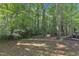Expansive backyard featuring a patio and fire pit area, perfect for outdoor entertaining and relaxation at 309 Penn Oak Cir, Raleigh, NC 27615