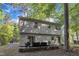 Two-story home with a patio area, outdoor seating and surrounded by mature trees at 309 Penn Oak Cir, Raleigh, NC 27615