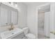 Bright bathroom features modern sink and vanity and marble-tiled shower with tub at 309 Penn Oak Cir, Raleigh, NC 27615