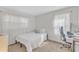 Bright bedroom features a bed, large window, and desk area at 309 Penn Oak Cir, Raleigh, NC 27615