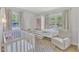 Bright Bedroom features a crib, an open closet, and comfortable chair at 309 Penn Oak Cir, Raleigh, NC 27615