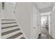 Entryway with hardwood stairs, light walls, and visible doorways at 309 Penn Oak Cir, Raleigh, NC 27615