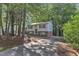 Traditional two-story home with a brick foundation, surrounded by mature trees and a long driveway at 309 Penn Oak Cir, Raleigh, NC 27615
