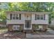 Charming two-story home with light siding, brick accents, and symmetrical windows and shutters at 309 Penn Oak Cir, Raleigh, NC 27615
