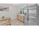 Well-lit dining area adjacent to a kitchen with stainless steel appliances and a storage cabinet at 309 Penn Oak Cir, Raleigh, NC 27615