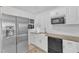 Bright kitchen with stainless steel refrigerator, subway tile backsplash, granite countertops, and white cabinets at 309 Penn Oak Cir, Raleigh, NC 27615