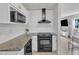 Updated kitchen with stainless steel appliances, granite countertops, tile backsplash, and modern fixtures at 309 Penn Oak Cir, Raleigh, NC 27615