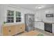 Bright kitchen with stainless steel appliances, subway tile backsplash, and a large window at 309 Penn Oak Cir, Raleigh, NC 27615