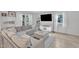 Comfortable living room with a large grey sectional couch, large windows, and sleek decor at 309 Penn Oak Cir, Raleigh, NC 27615