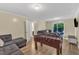 Open living room boasts abundant natural light, wood floors, and space for entertaining at 309 Penn Oak Cir, Raleigh, NC 27615