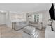 Living room with light colored floors, light colored sofa, and a large window for natural light at 309 Penn Oak Cir, Raleigh, NC 27615