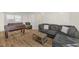 Spacious living room featuring hardwood floors, a foosball table, and a comfortable sectional sofa at 309 Penn Oak Cir, Raleigh, NC 27615