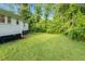 Spacious backyard offering privacy with mature trees, perfect for outdoor activities at 313 W Church St, Angier, NC 27501