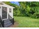 Lush backyard with grassy area and bordering lush green trees at 313 W Church St, Angier, NC 27501