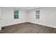 Bright bedroom with vinyl floors, two windows, and neutral walls at 313 W Church St, Angier, NC 27501