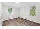 Bright bedroom with vinyl floors, two windows, and white trim at 313 W Church St, Angier, NC 27501