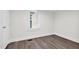 Well-lit bedroom with vinyl flooring, a window, and base trim at 313 W Church St, Angier, NC 27501