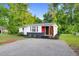 Charming renovated single-story home features a red accent wall and updated landscaping at 313 W Church St, Angier, NC 27501
