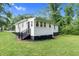 Well-maintained home with white siding, black accents, a welcoming entrance, and a lush green yard at 313 W Church St, Angier, NC 27501