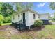 Charming home featuring white siding, black accents, manicured landscaping, and a welcoming entrance at 313 W Church St, Angier, NC 27501
