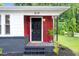 Inviting front door, red siding, black accents, and landscaped entrance at 313 W Church St, Angier, NC 27501