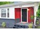 Inviting front entrance with red paneling, black door, and landscaped plants, and a welcome mat at 313 W Church St, Angier, NC 27501
