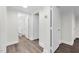 Bright hallway featuring vinyl floors and multiple doors, leading to various rooms at 313 W Church St, Angier, NC 27501