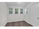 Cozy living room with natural light from three windows and wood-look flooring, perfect for relaxation at 313 W Church St, Angier, NC 27501