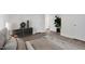 Bright main bedroom with vinyl floors, plants, black dresser, and light colors at 313 W Church St, Angier, NC 27501