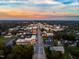 Aerial view showcasing the cityscape and surrounding trees, capturing a vibrant sunset at 315 New Twin Branch Ct, Smithfield, NC 27577