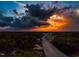 Aerial view showing a road leading through trees with a dramatic sunset in the background at 315 New Twin Branch Ct, Smithfield, NC 27577