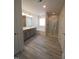 Bright bathroom with a double vanity, bathtub, and glass enclosed shower at 315 New Twin Branch Ct, Smithfield, NC 27577