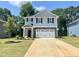 Charming two-story home featuring a two-car garage, stone accents, and a well-manicured lawn, perfect for suburban living at 315 New Twin Branch Ct, Smithfield, NC 27577