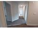 Hallway featuring neutral walls, carpet flooring, and bright lighting at 315 New Twin Branch Ct, Smithfield, NC 27577