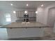 Kitchen island with granite countertop, gray cabinets, stainless steel sink and pendant lighting at 315 New Twin Branch Ct, Smithfield, NC 27577