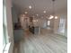 Open kitchen with gray cabinets, granite countertops, stainless appliances, and gray wood flooring at 315 New Twin Branch Ct, Smithfield, NC 27577
