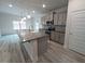 Kitchen island featuring granite countertops, gray cabinets, and stainless sink at 315 New Twin Branch Ct, Smithfield, NC 27577