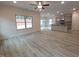 Spacious living room featuring gray wood flooring, ceiling fan, and bright windows at 315 New Twin Branch Ct, Smithfield, NC 27577