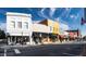 Street view of colorful storefronts under a clear blue sky, with an American flag visible at 315 New Twin Branch Ct, Smithfield, NC 27577