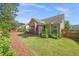 Spacious backyard featuring a lawn, screened porch with an American flag, and wooded border, perfect for outdoor enjoyment at 320 Trout Valley Rd, Wake Forest, NC 27587