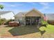 The backyard features a well-maintained lawn, screened in porch, and a hot tub at 320 Trout Valley Rd, Wake Forest, NC 27587